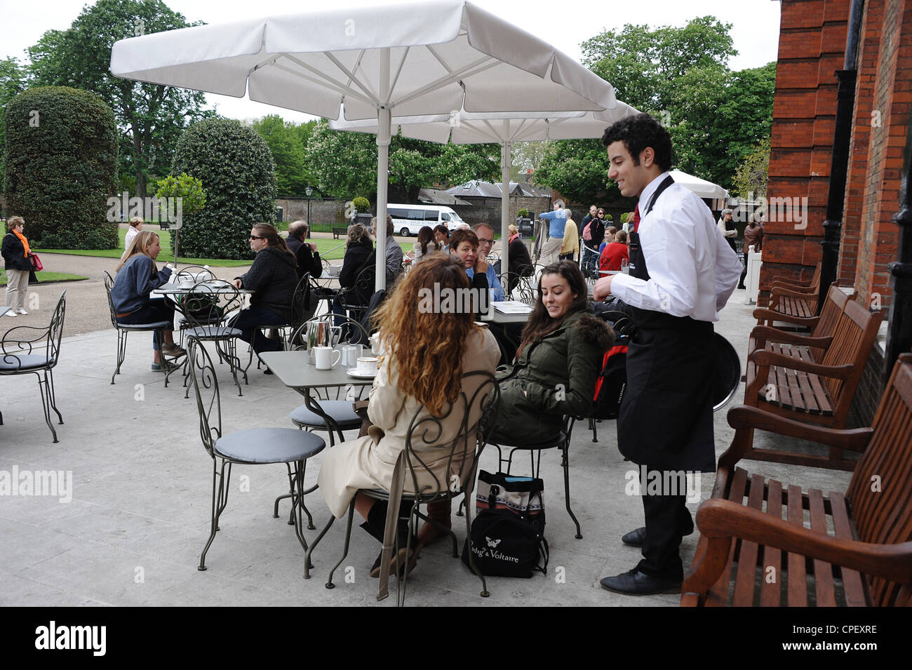 The Orangery in Kensington Gardens in London with customers sitting at tables outside. Stock Photo