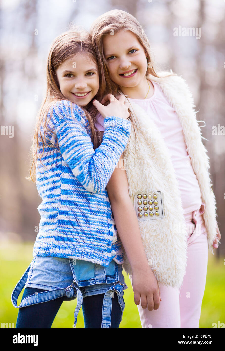 two girls embracing and laughing in the summer park Stock Photo - Alamy