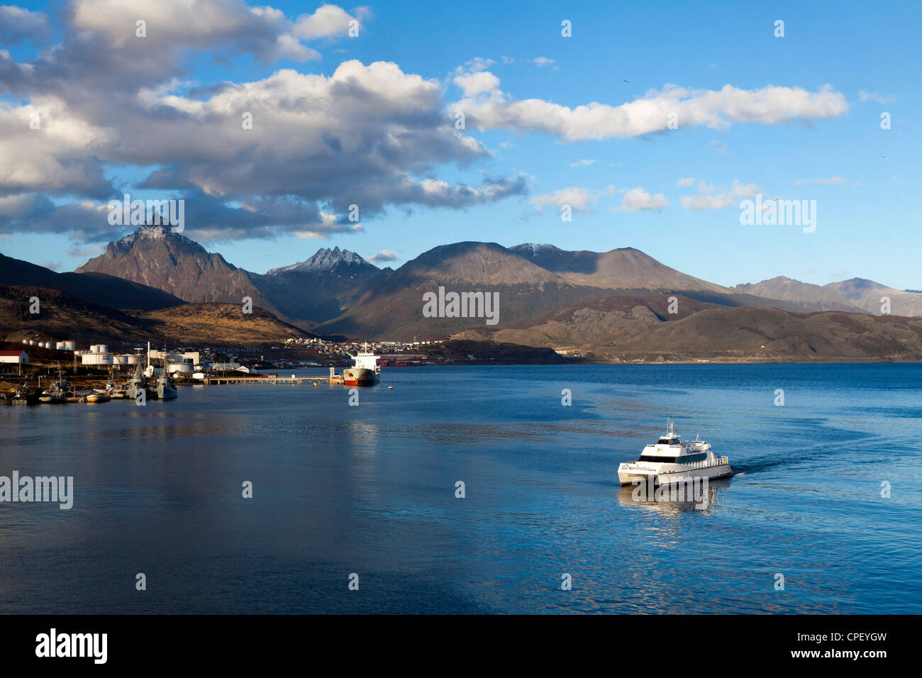 Tourist catamaran arriving in Ushuaia in the late afternoon, Tierra del Fuego, Argentina Stock Photo