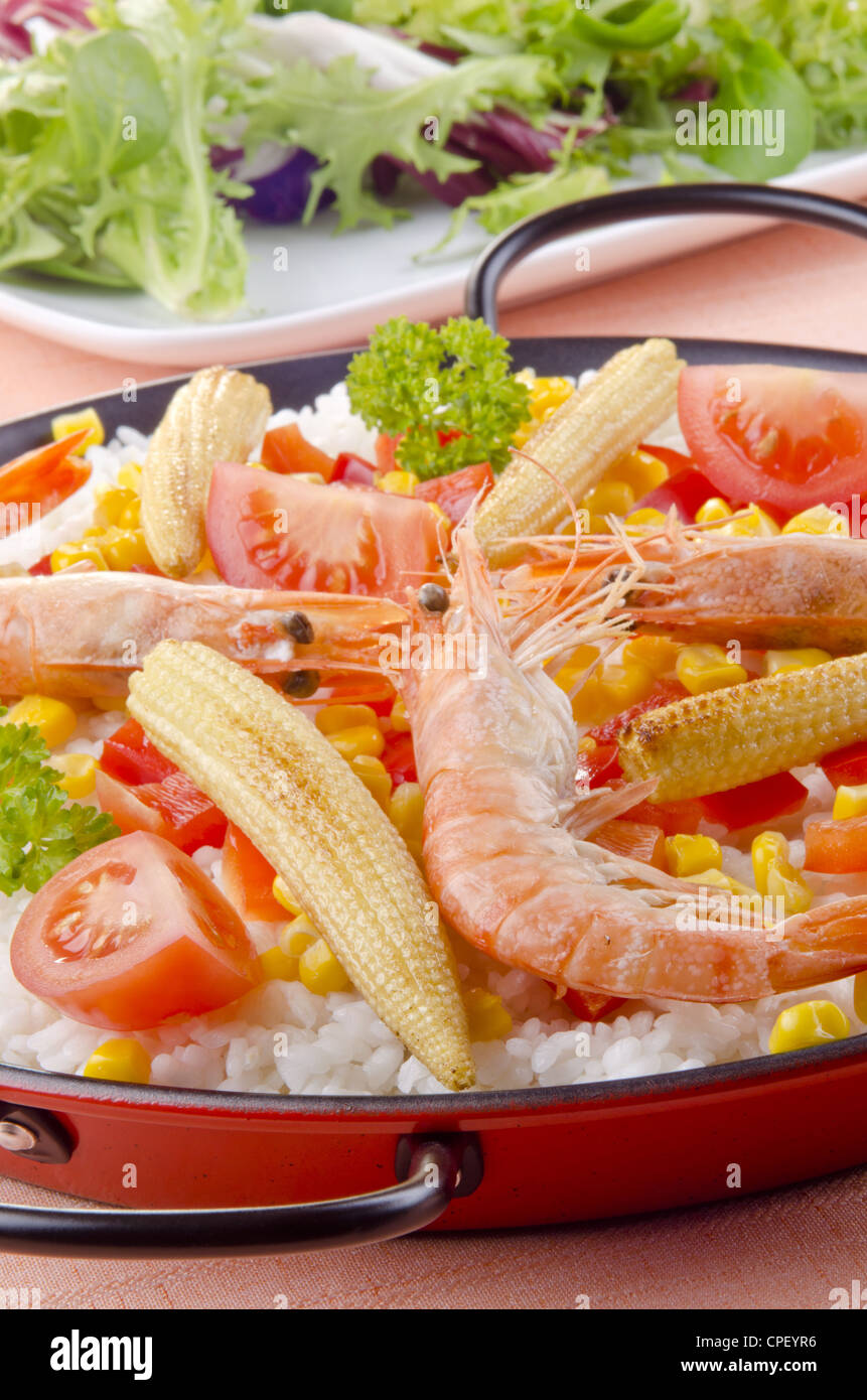spanish paella with bell pepper, babycorn and shrimps Stock Photo