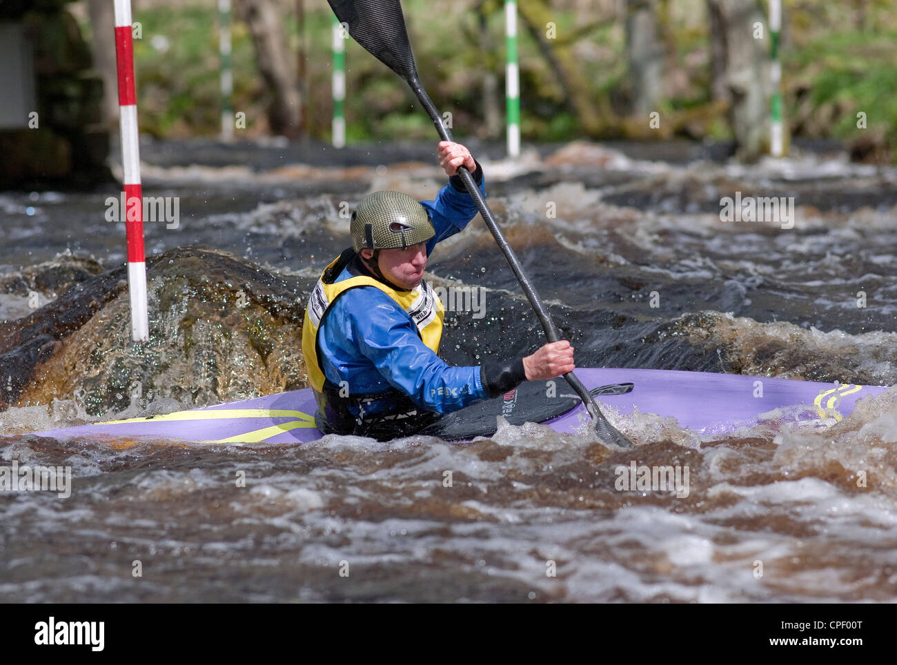 Male competitor in a slalom kayak competition, at the Washburn Valley, North Yorkshire April 2012 Stock Photo
