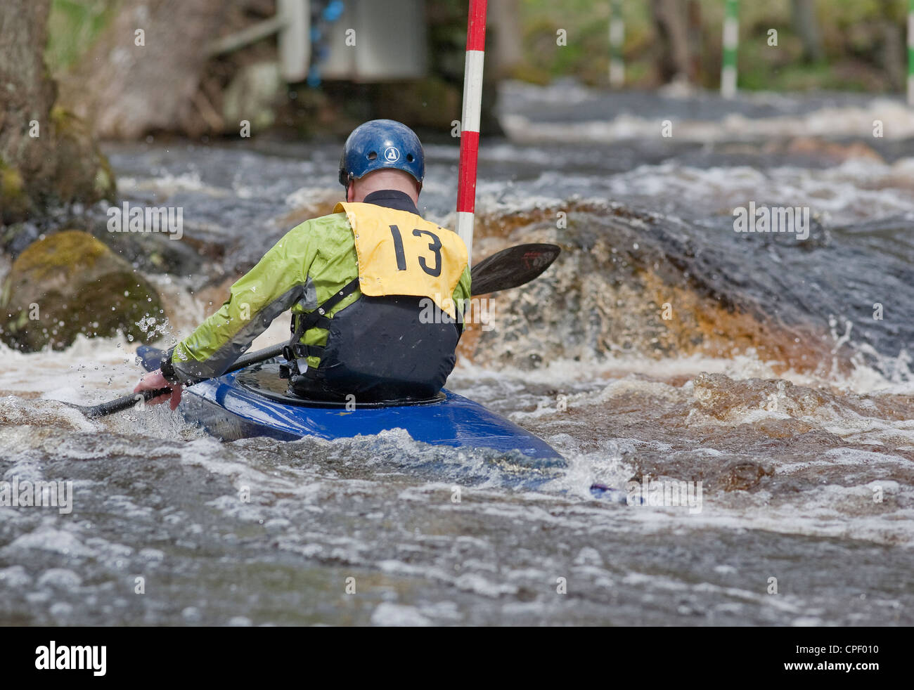 Male competitor in a slalom kayak competition, at the Washburn Valley, North Yorkshire April 2012 Stock Photo