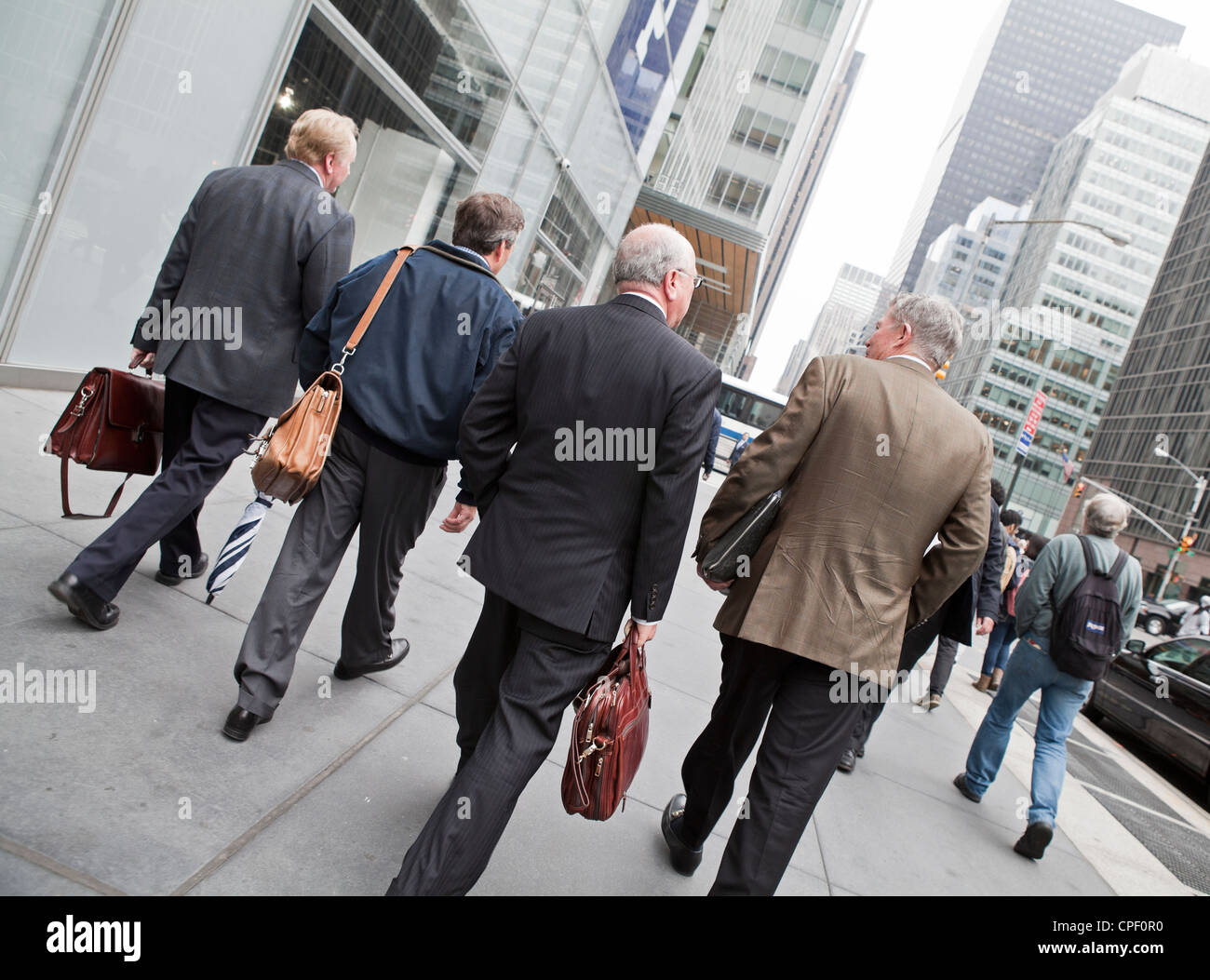 4 businessmen walk down the street in New York City Stock Photo Alamy