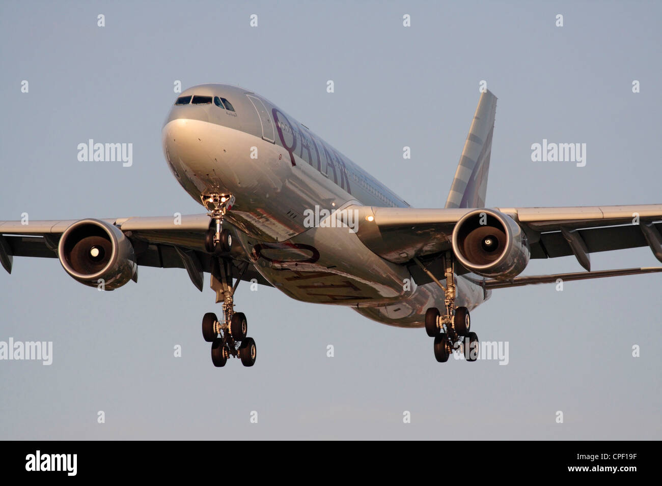 Qatar Airways Airbus A330-200 widebody airliner on arrival at sunset. Head on view. Stock Photo