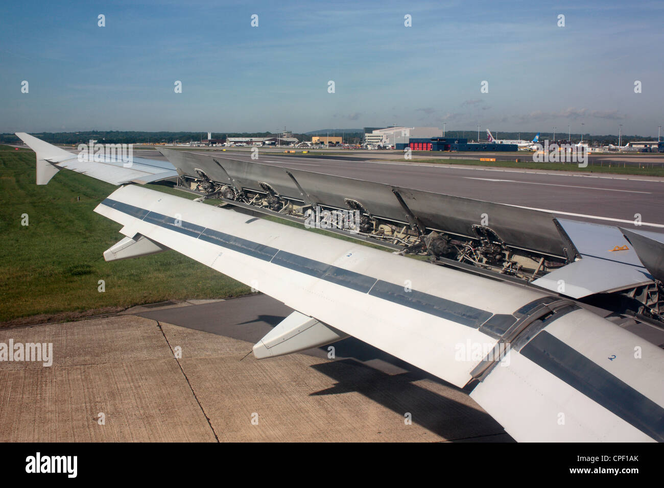 Wing of an Airbus A320 jet plane after landing with spoilers up and flaps down for high drag. Aerodynamics and aircraft design Stock Photo