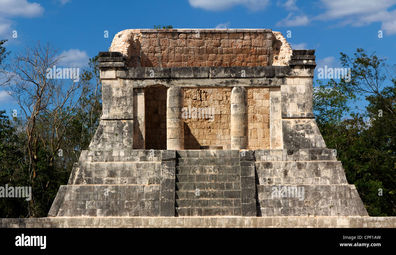 Building of Mayan origin, thought to be a ceremonial throne room, rises out of the jungle at Chichen. Stock Photo