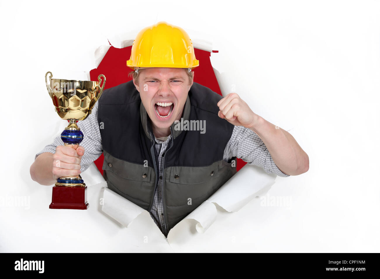 Proud builder holding trophy Stock Photo