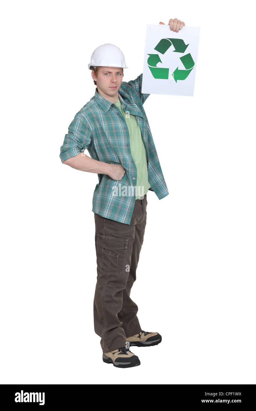 Builder holding the universal recycling symbol Stock Photo