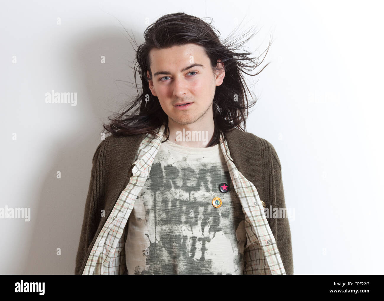 Half Length Colour Studio Portrait Of Male With Long Hair Wearing A Green Knitted Jumper And White Checkered Shirt Stock Photo Alamy