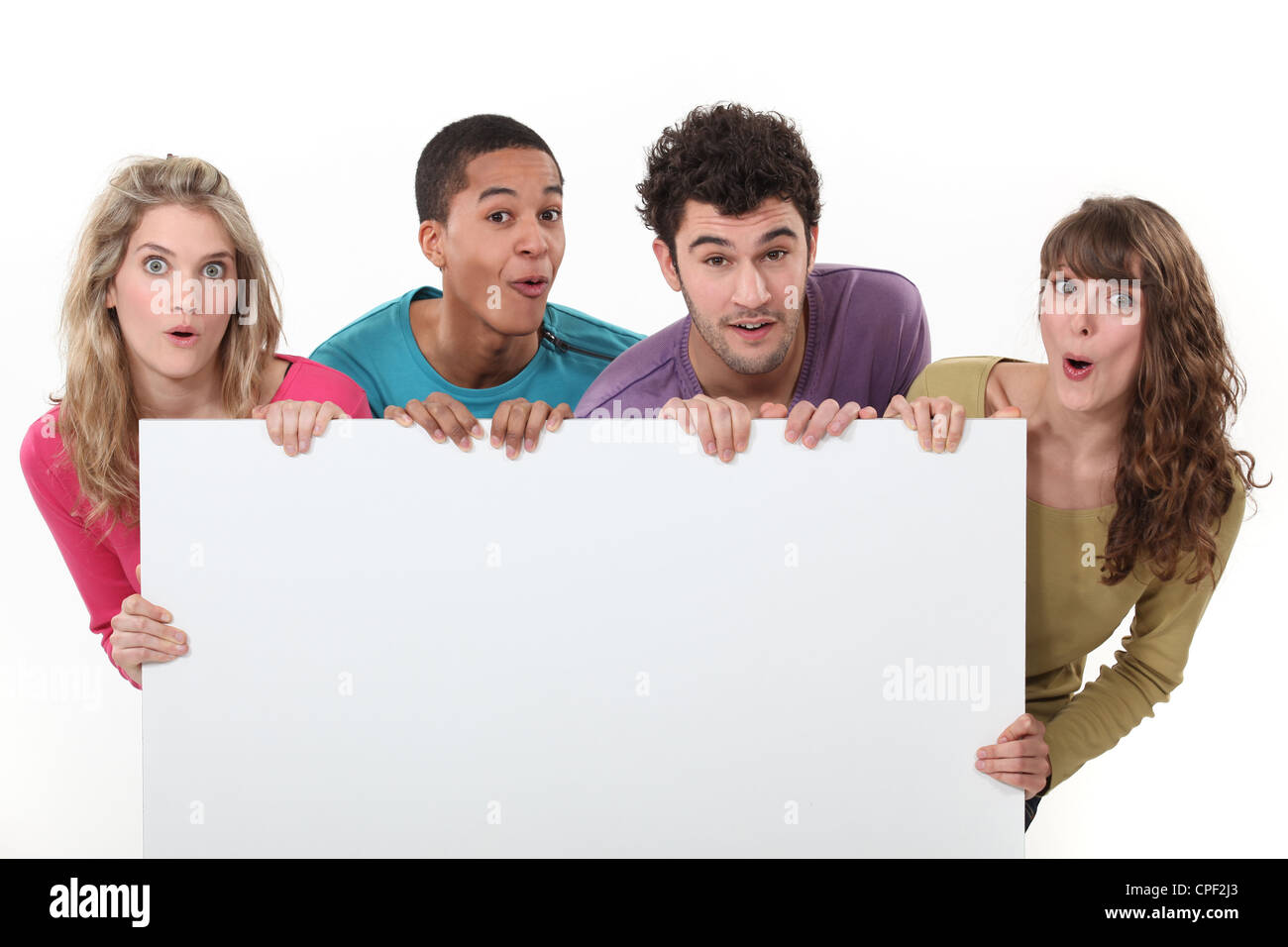 Bunch of teenagers holding a blank poster Stock Photo - Alamy