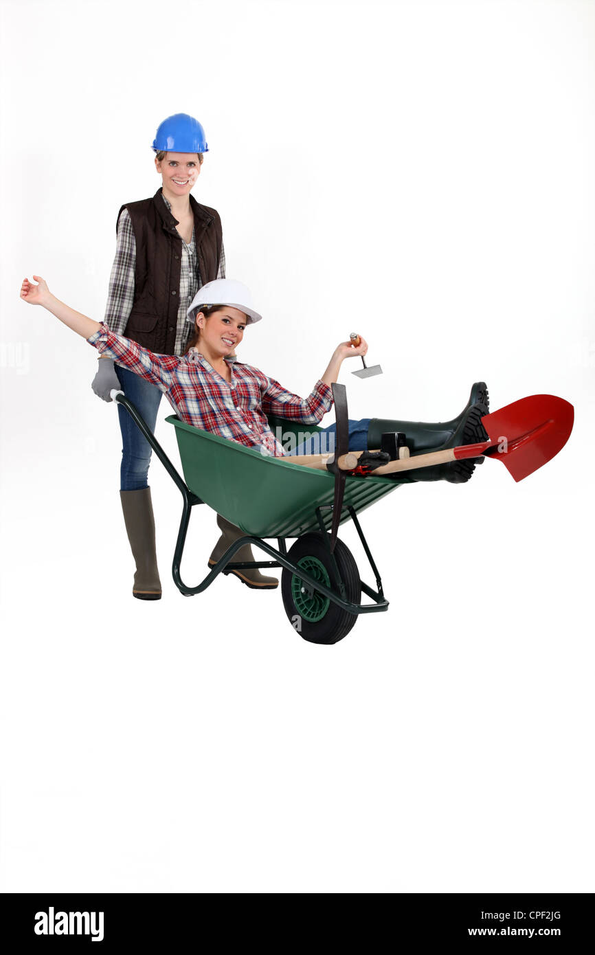 Two women with wheelbarrow Stock Photo - Alamy