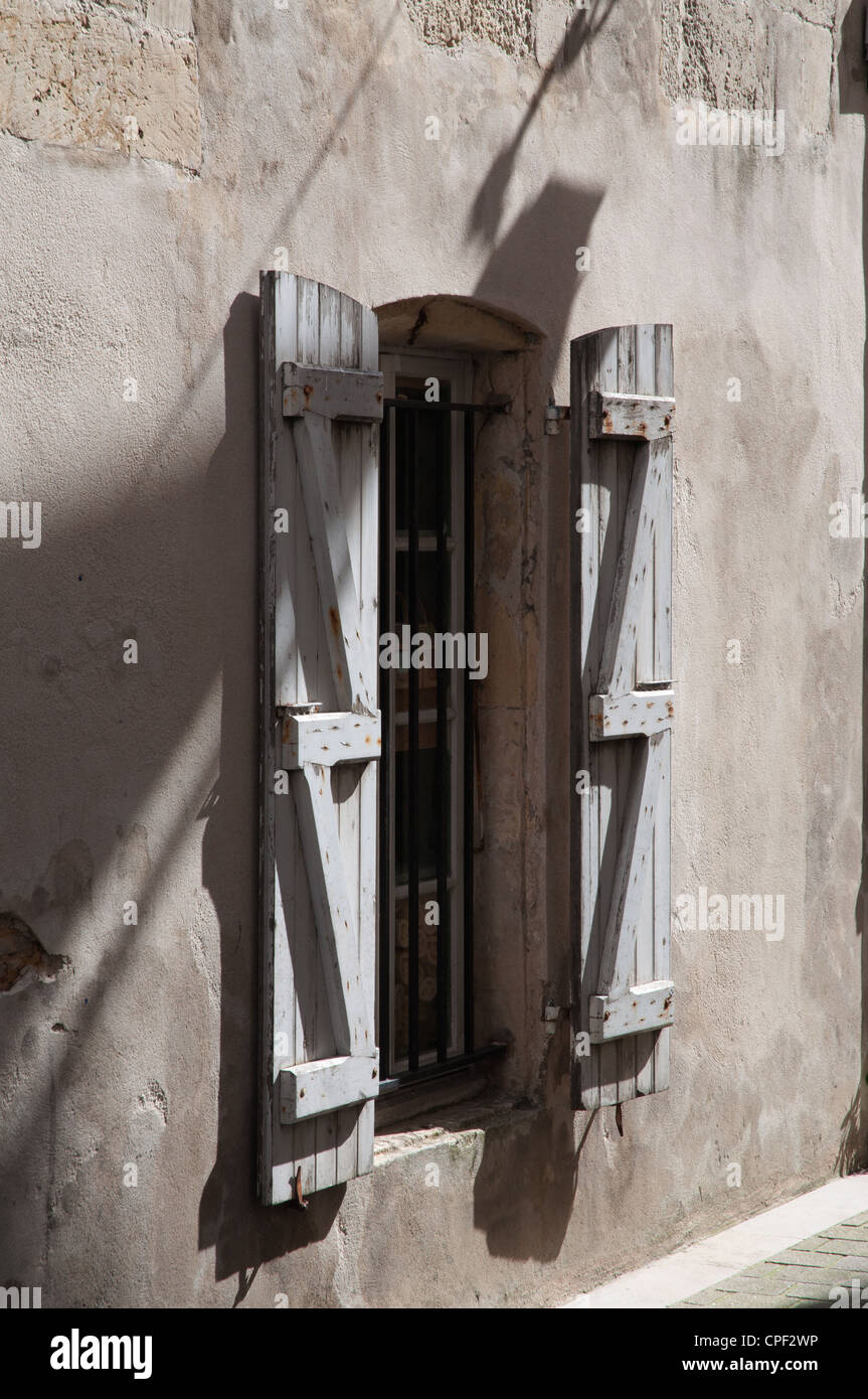 old wooden shutters for window French rural village sunlight and shadows Stock Photo