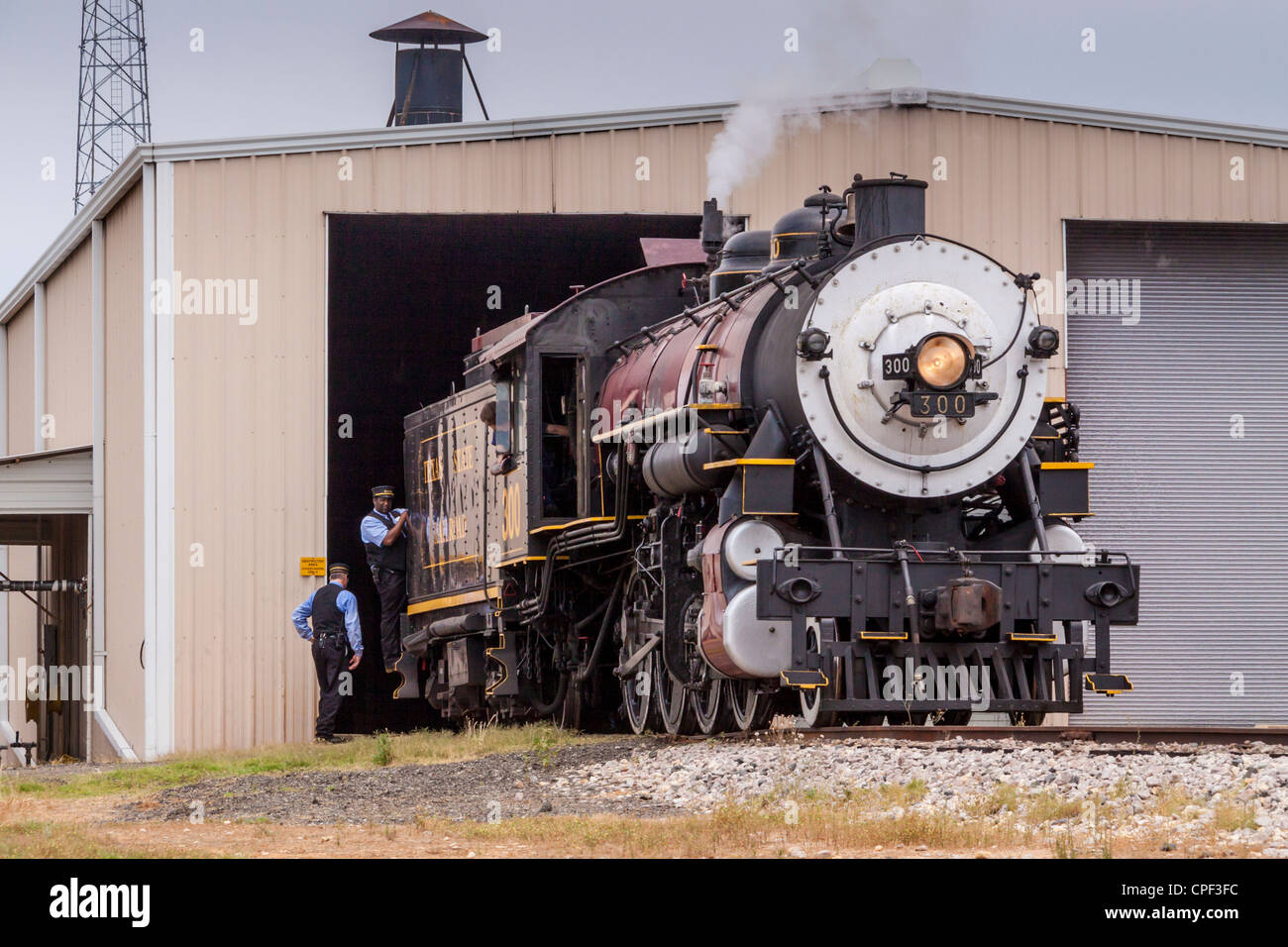 1917 Baldwin 'Pershing' steam engine locomotive 300 pushing larger 610 engine into maintenance shed of 'Texas State Railroad', Palestine, Texas. Stock Photo