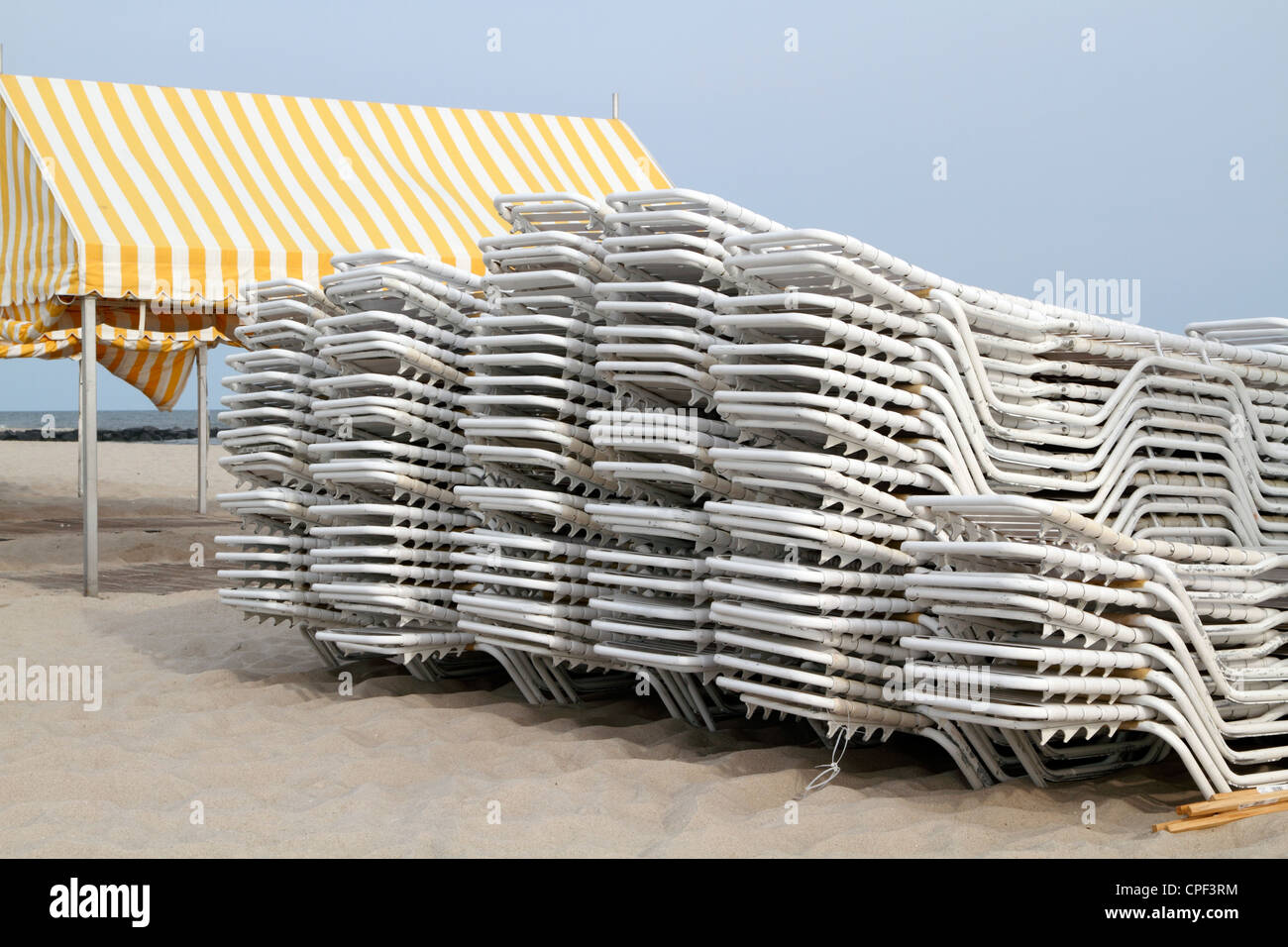 Beach chairs stacked next to a cabana on the beach in Cape May, New