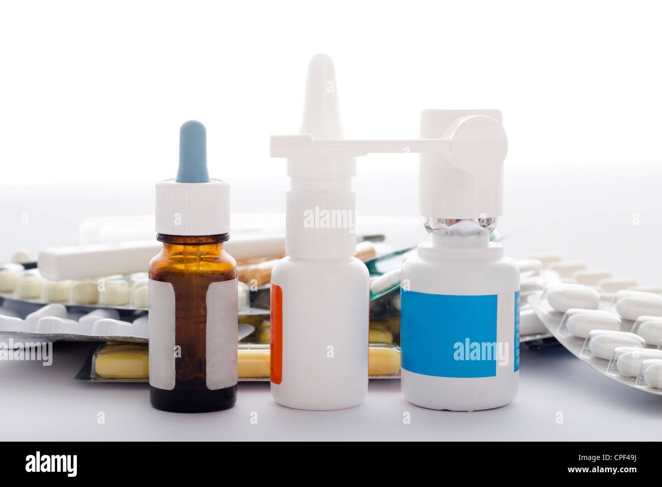 Medical supplies, nose drops, nasal spray, oral spray, pills, tablets and capsules. Isolated on white background. Stock Photo