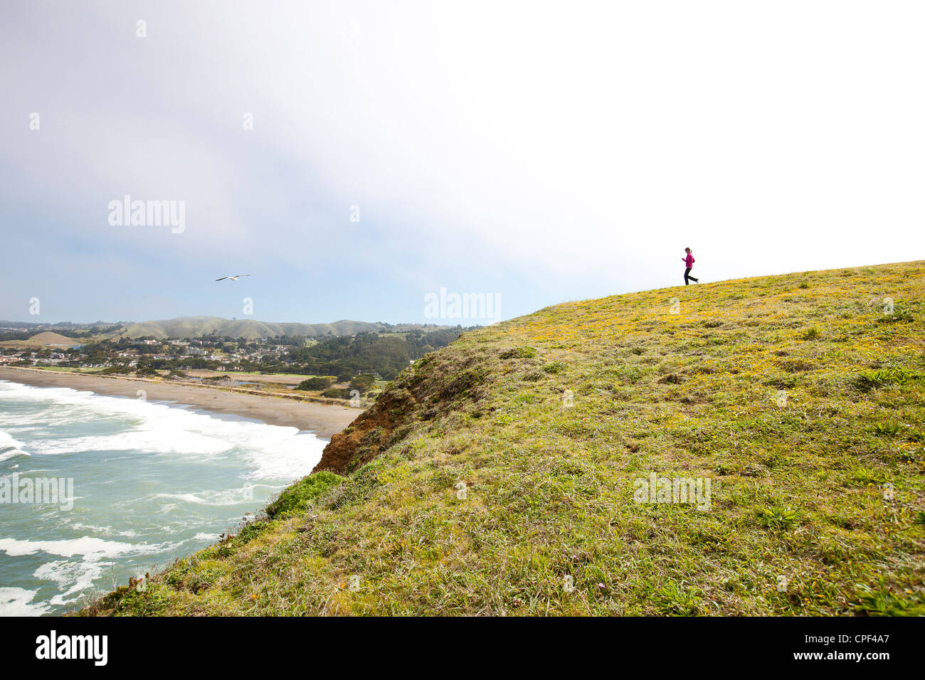 woman running hillside Stock Photo