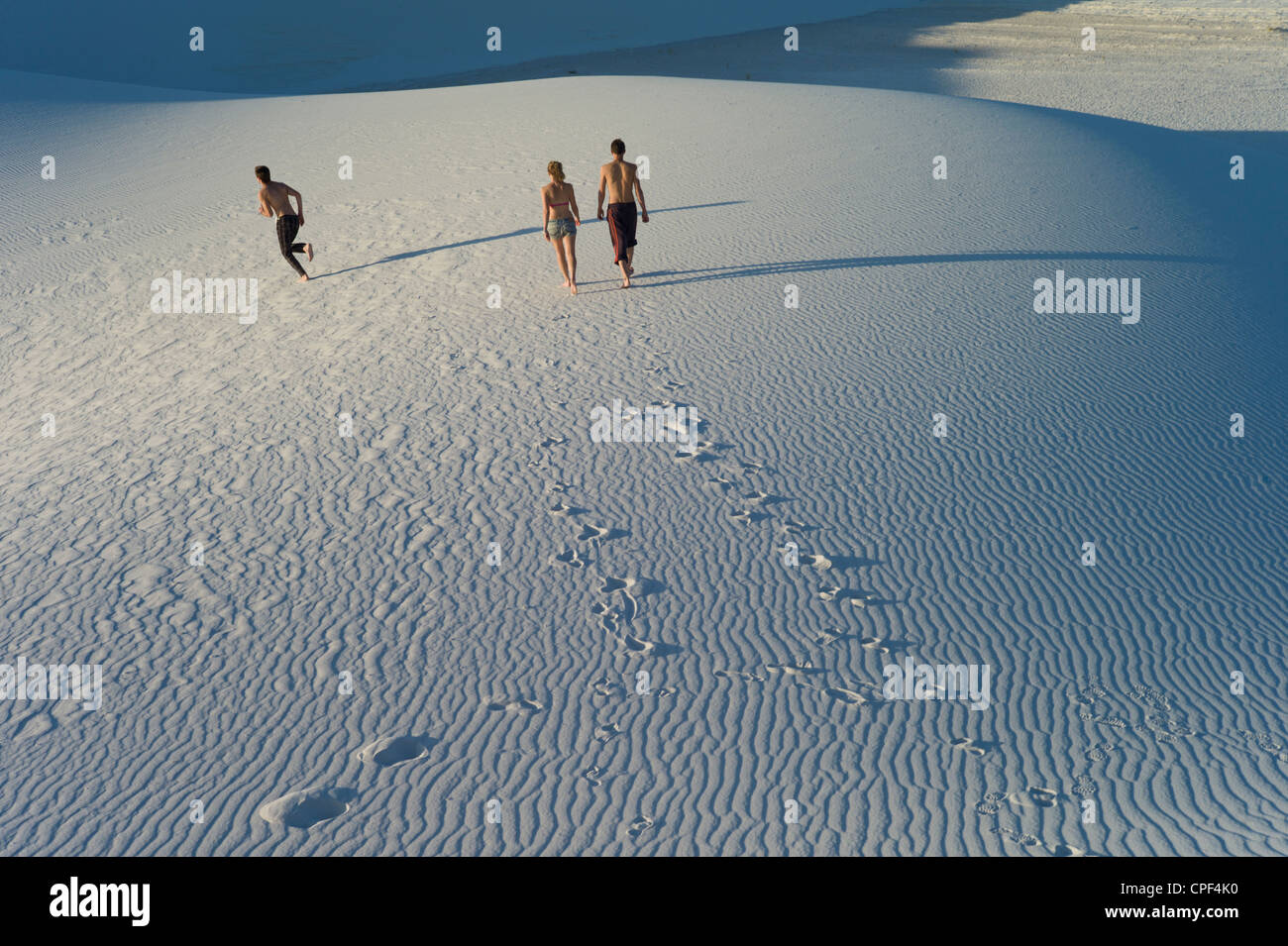 Young people walking across the sand in While Sands National Monument