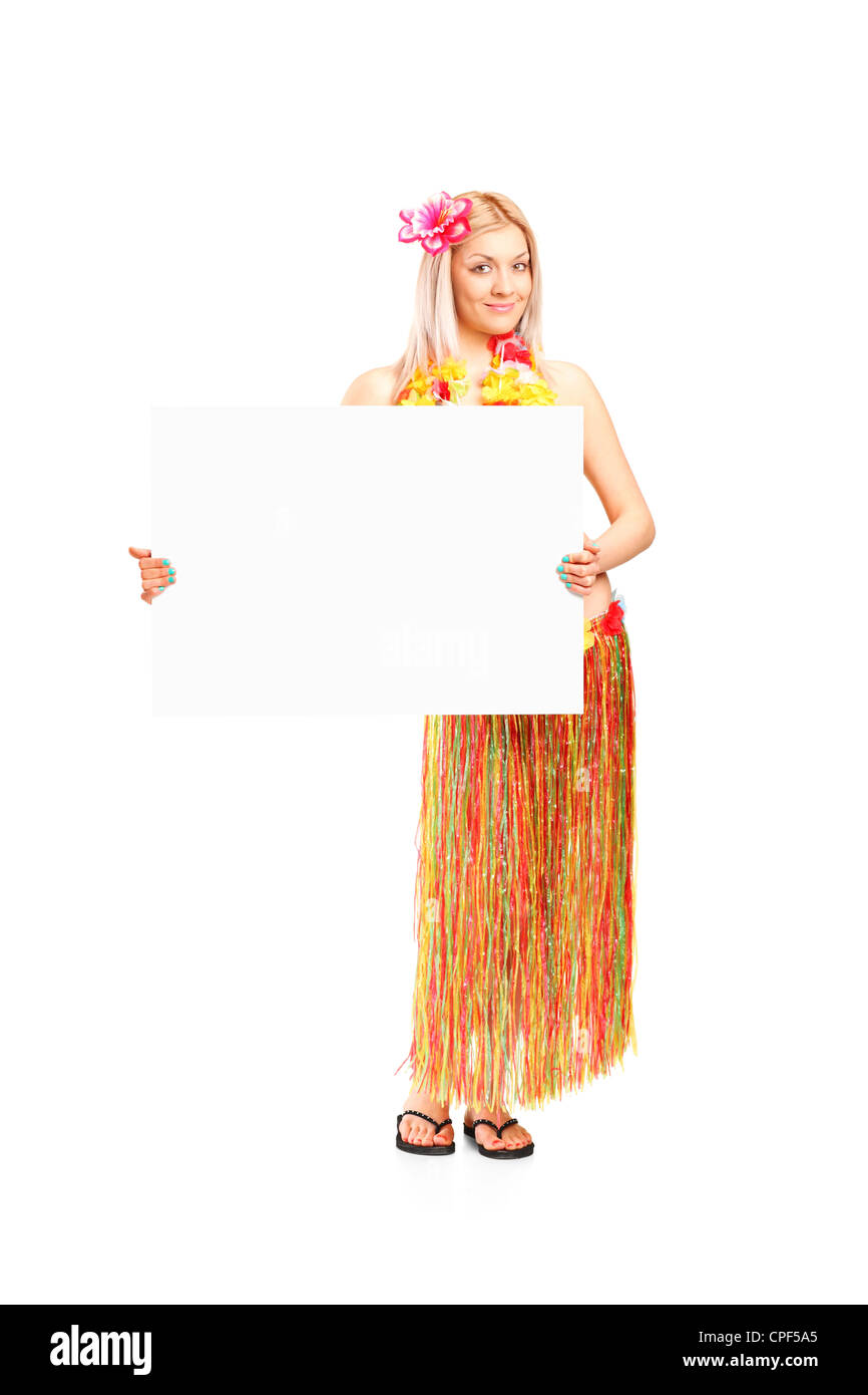 Full length portrait of an attractive young woman dressed in a hawaiian costume holding a white panel isolated on white backgrou Stock Photo