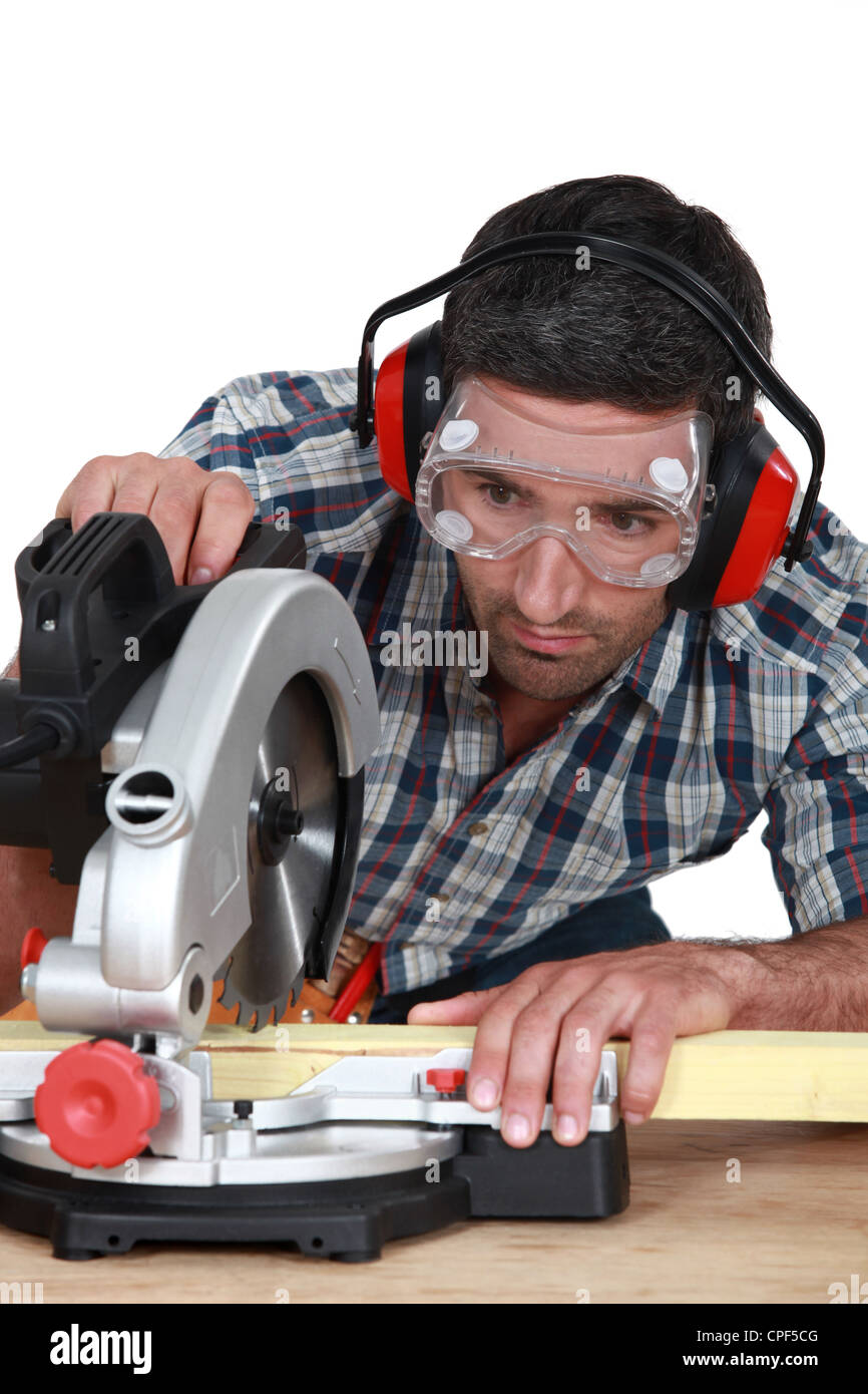 Man using circular saw to cut wood Stock Photo