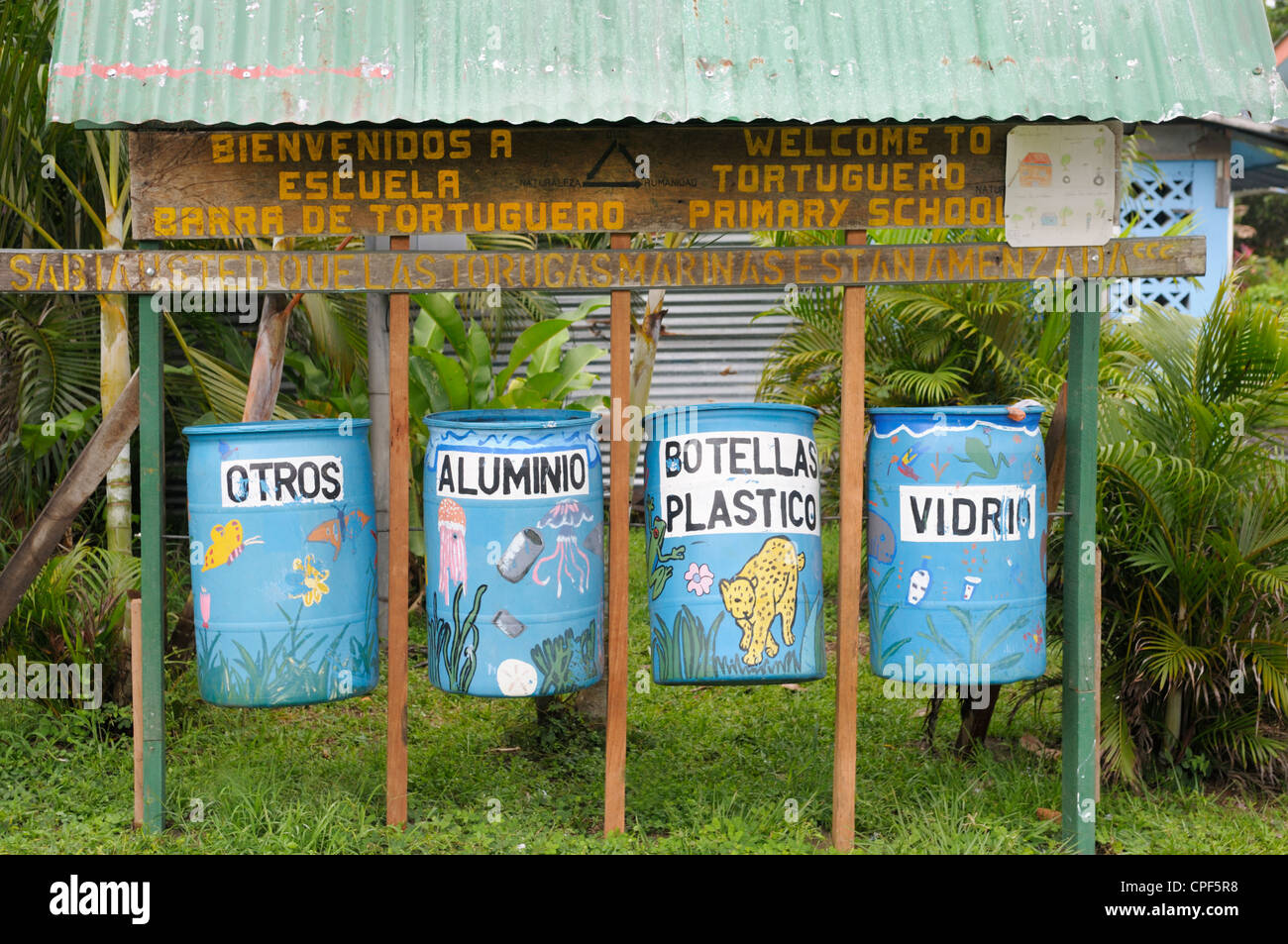 Trash and recycling bins outside a school, Tortuguero, Costa Rica Stock