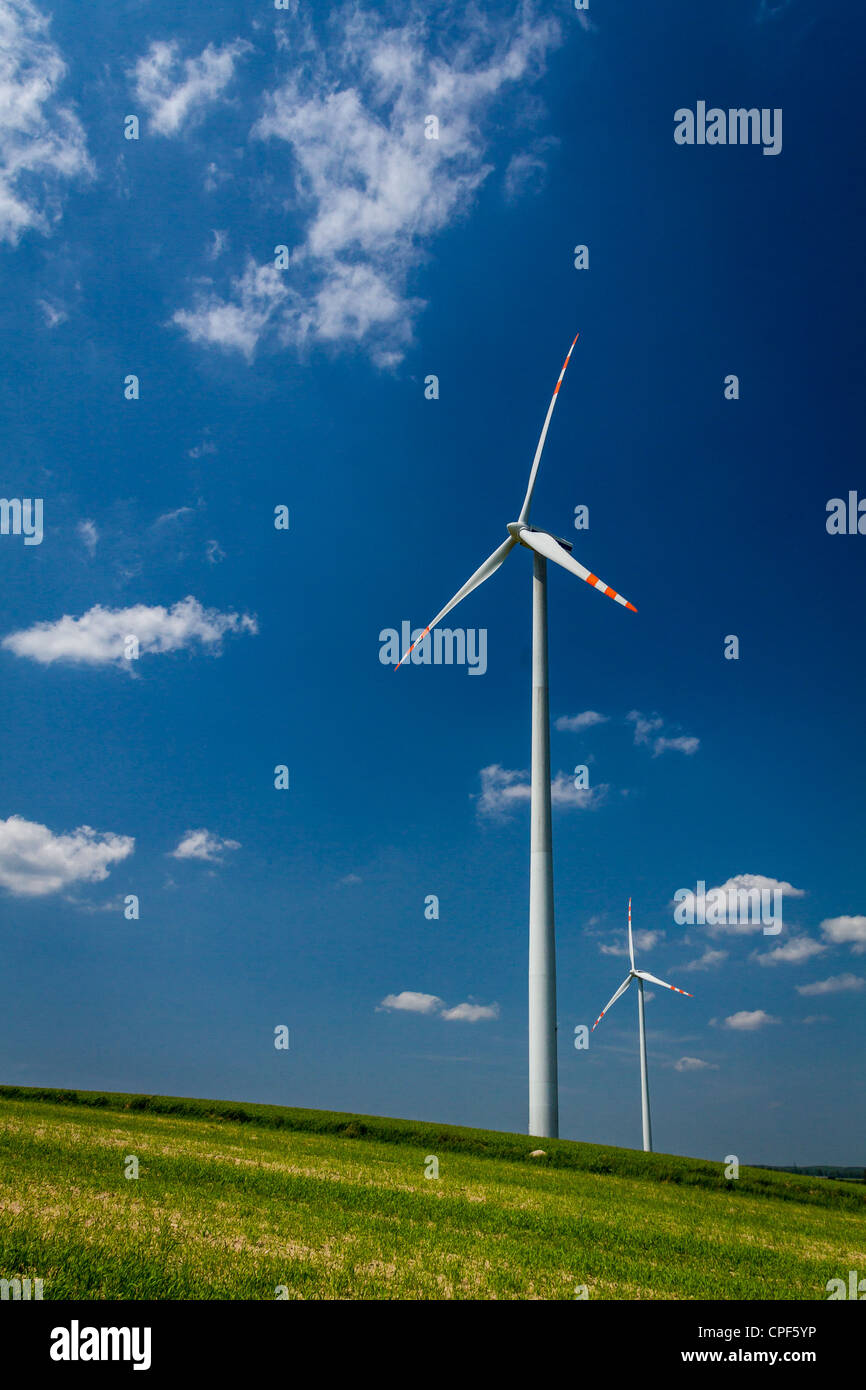 Wind Turbines on green field with blue sky Stock Photo - Alamy