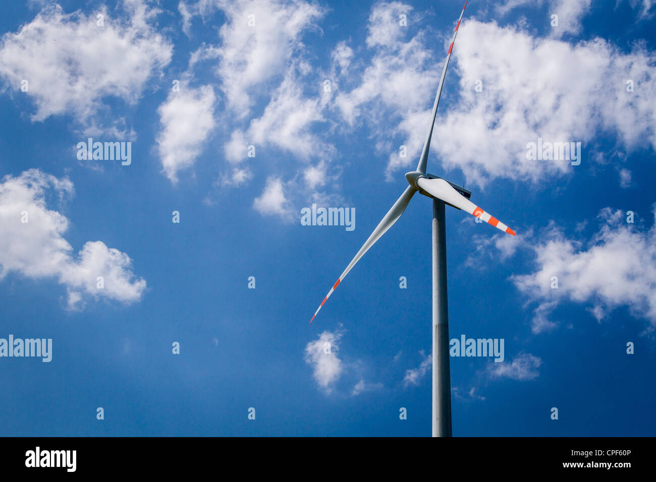 Wind turbine on blue sky background Stock Photo - Alamy