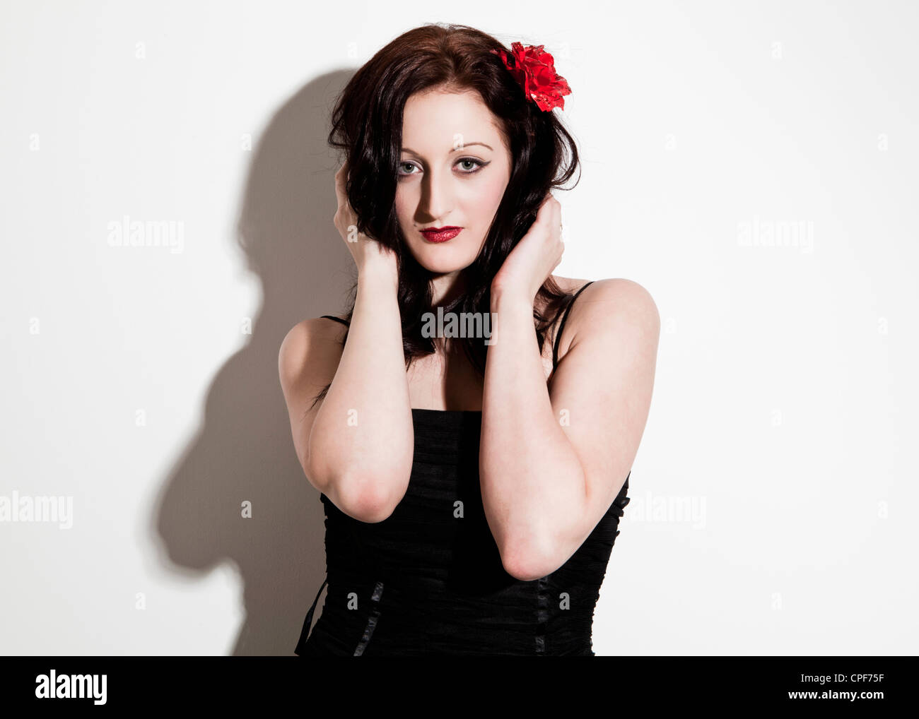 Half length colour studio portrait of female model wearing a black ...