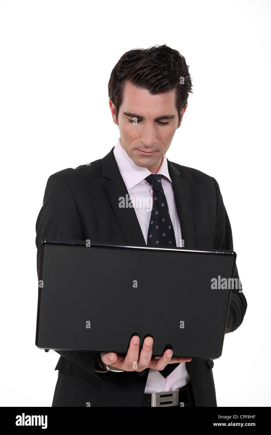 Confident businessman with laptop computer Stock Photo