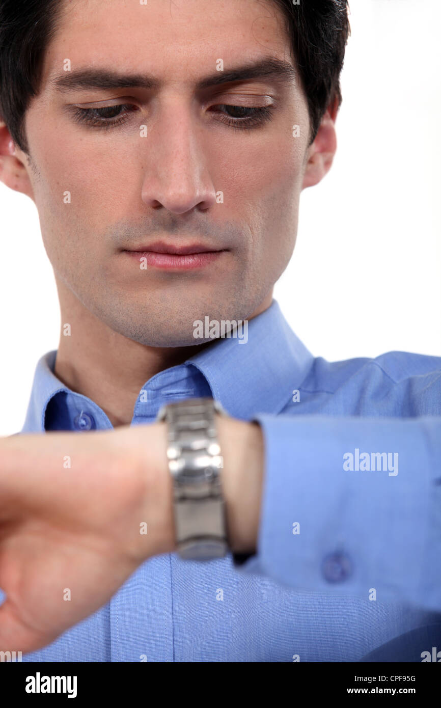 Young businessman checking the time Stock Photo - Alamy