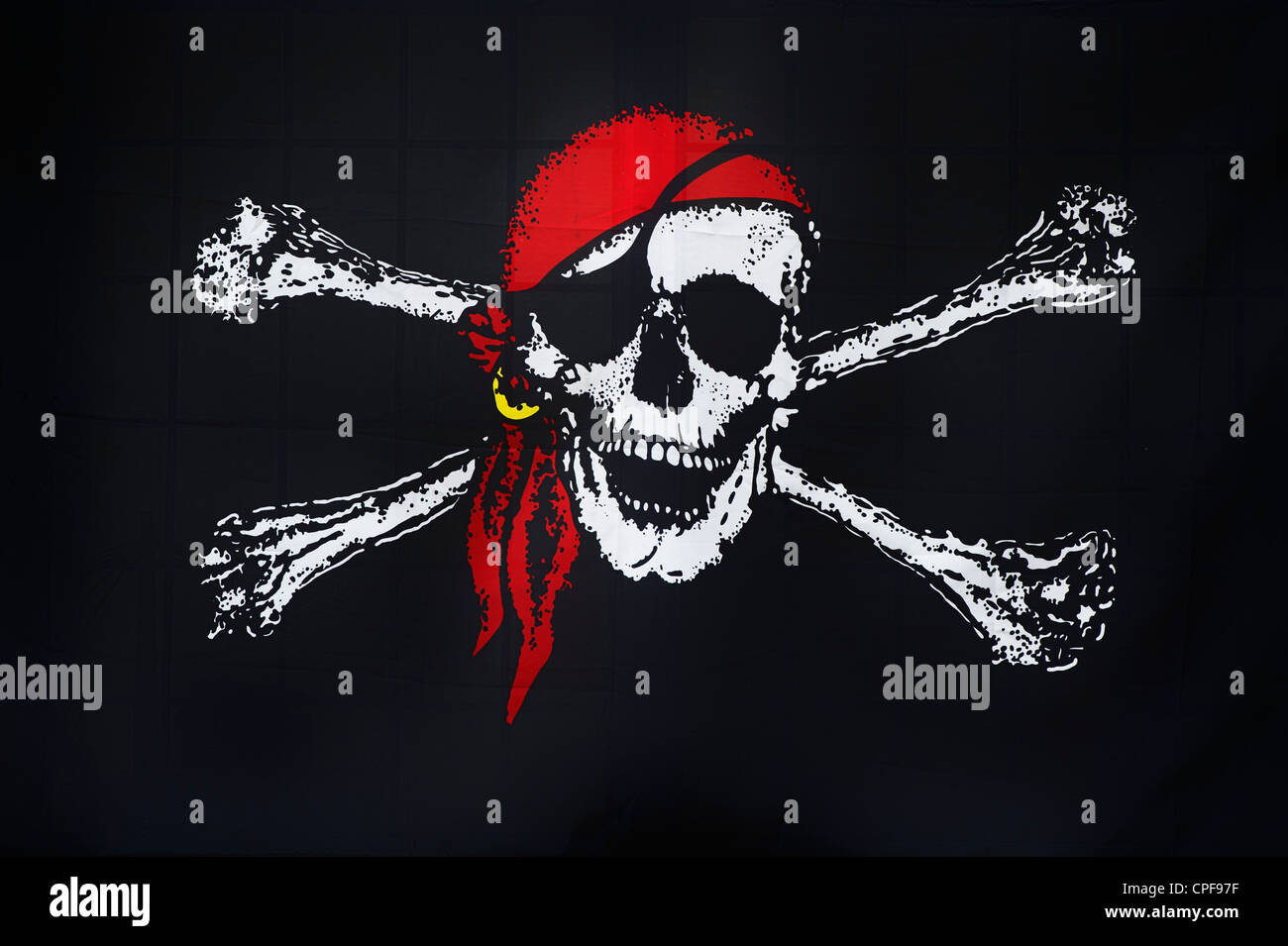 Jolly Roger pirate flag in bar window, Brixham, Devon, England Stock Photo