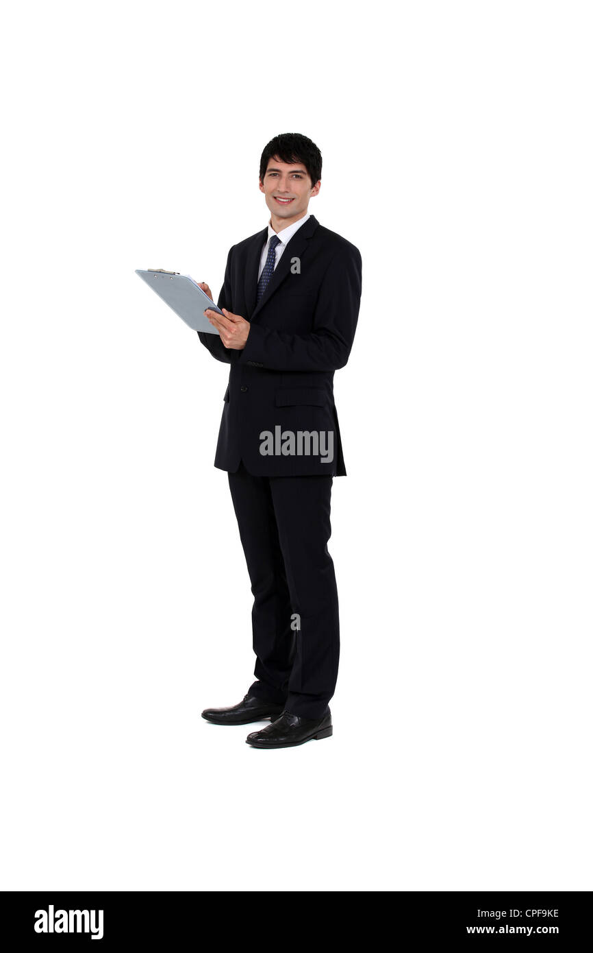 Businessman writing on a clipboard Stock Photo - Alamy
