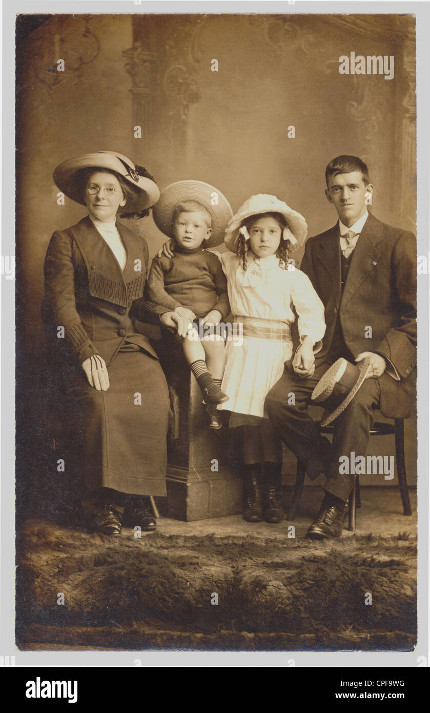 Original early 1900's postcard, studio portrait of a family just after the Edwardian era, circa 1912, U.K. Stock Photo