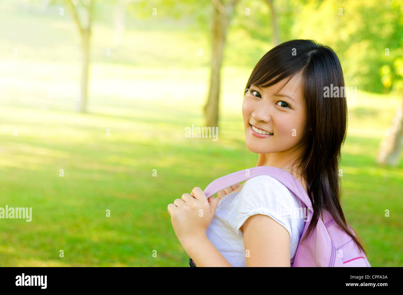 Asian university student walking on outside campus, green park Stock ...