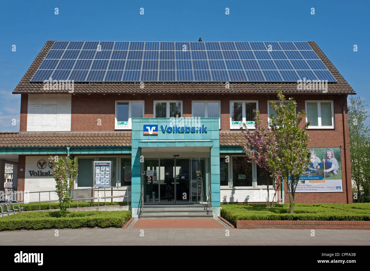 A branch of Volksbank with solar panels fitted to the roof Stock Photo