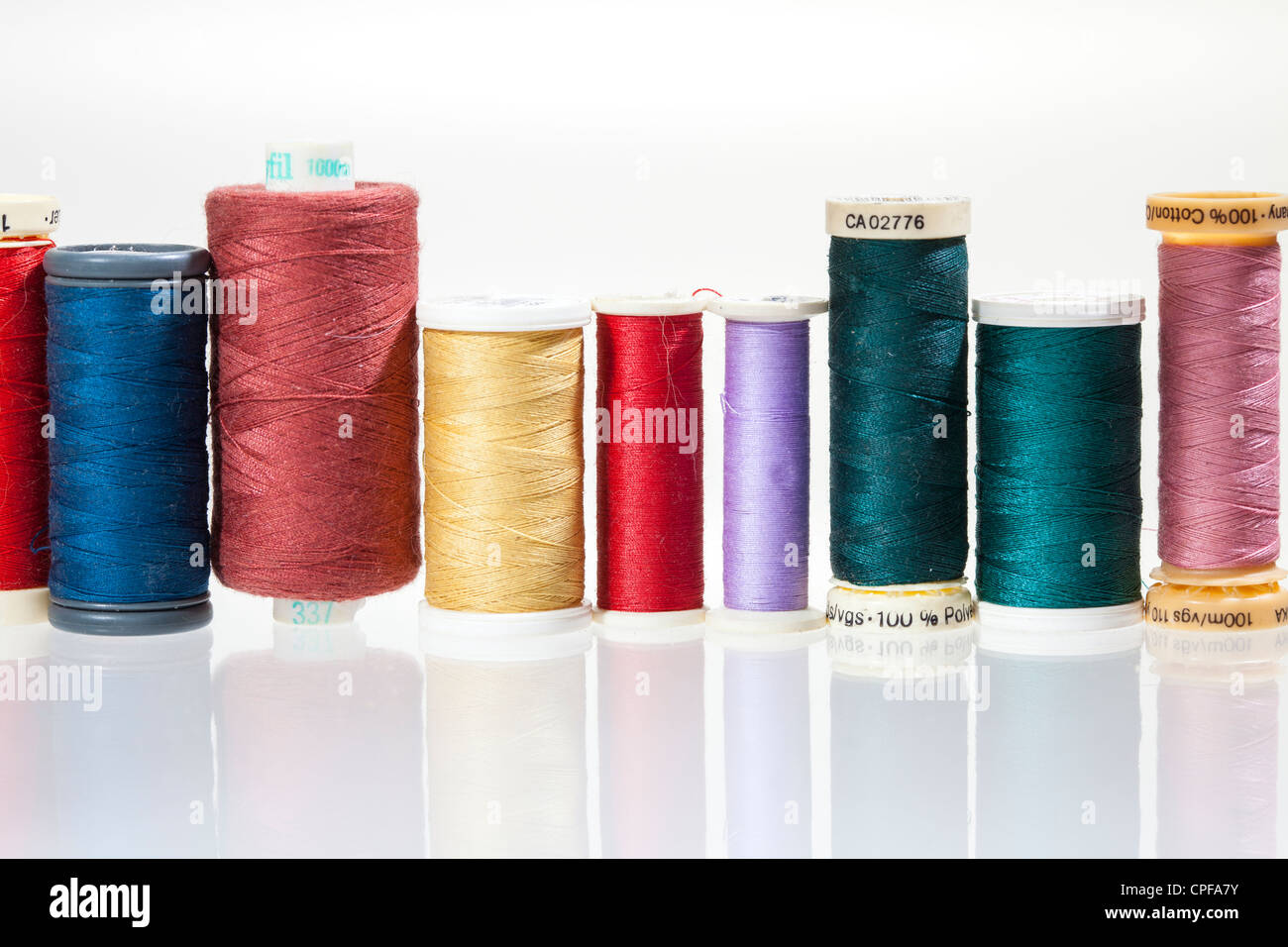 Sewing threads on bobbins in different colours Stock Photo Alamy