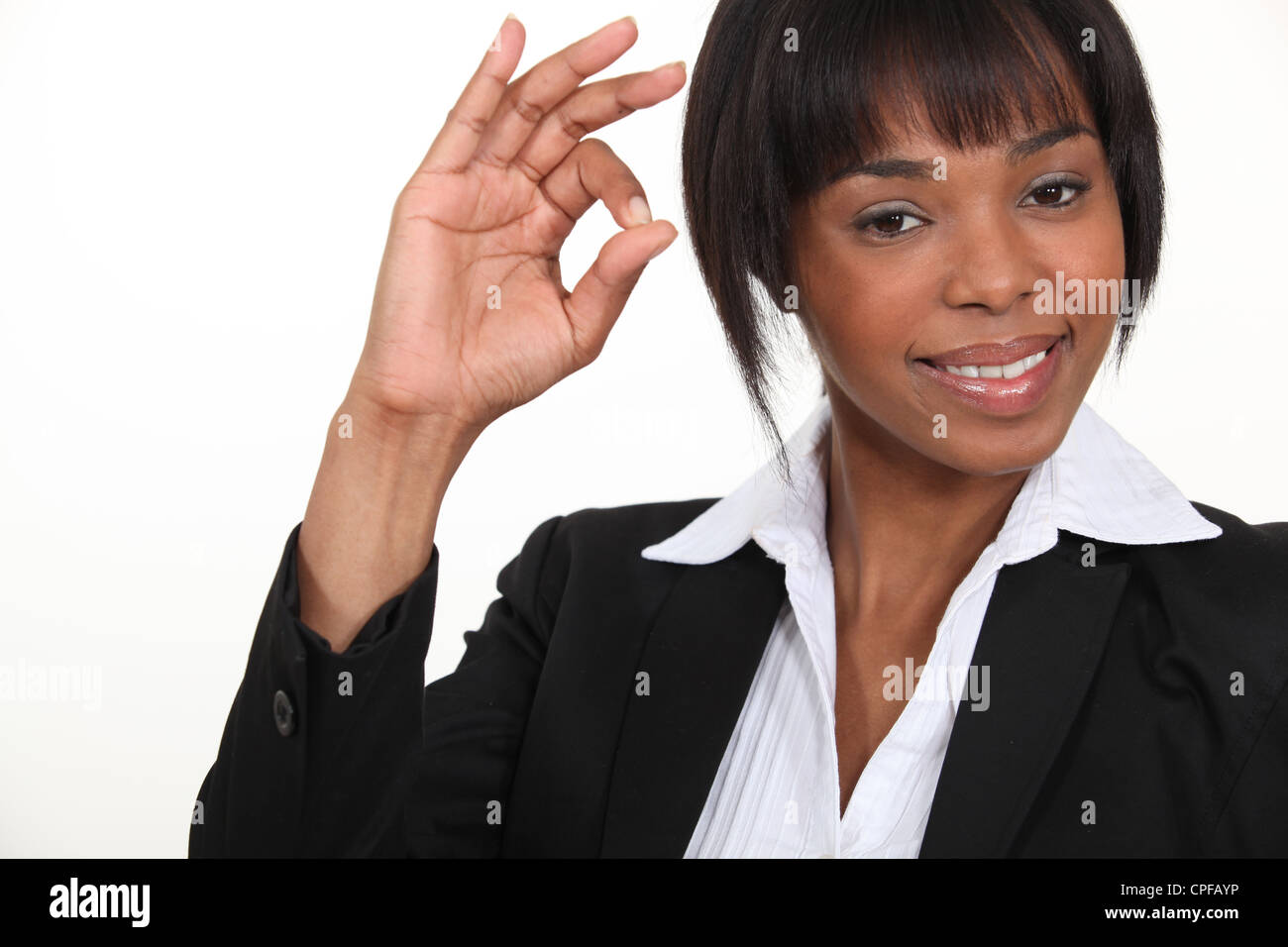 An African American businesswoman gesturing an ok sign Stock Photo - Alamy