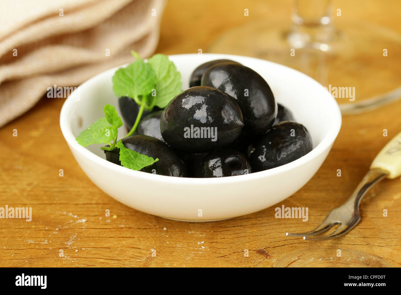 Pickle black olives in a bowl on a wooden table Stock Photo Alamy