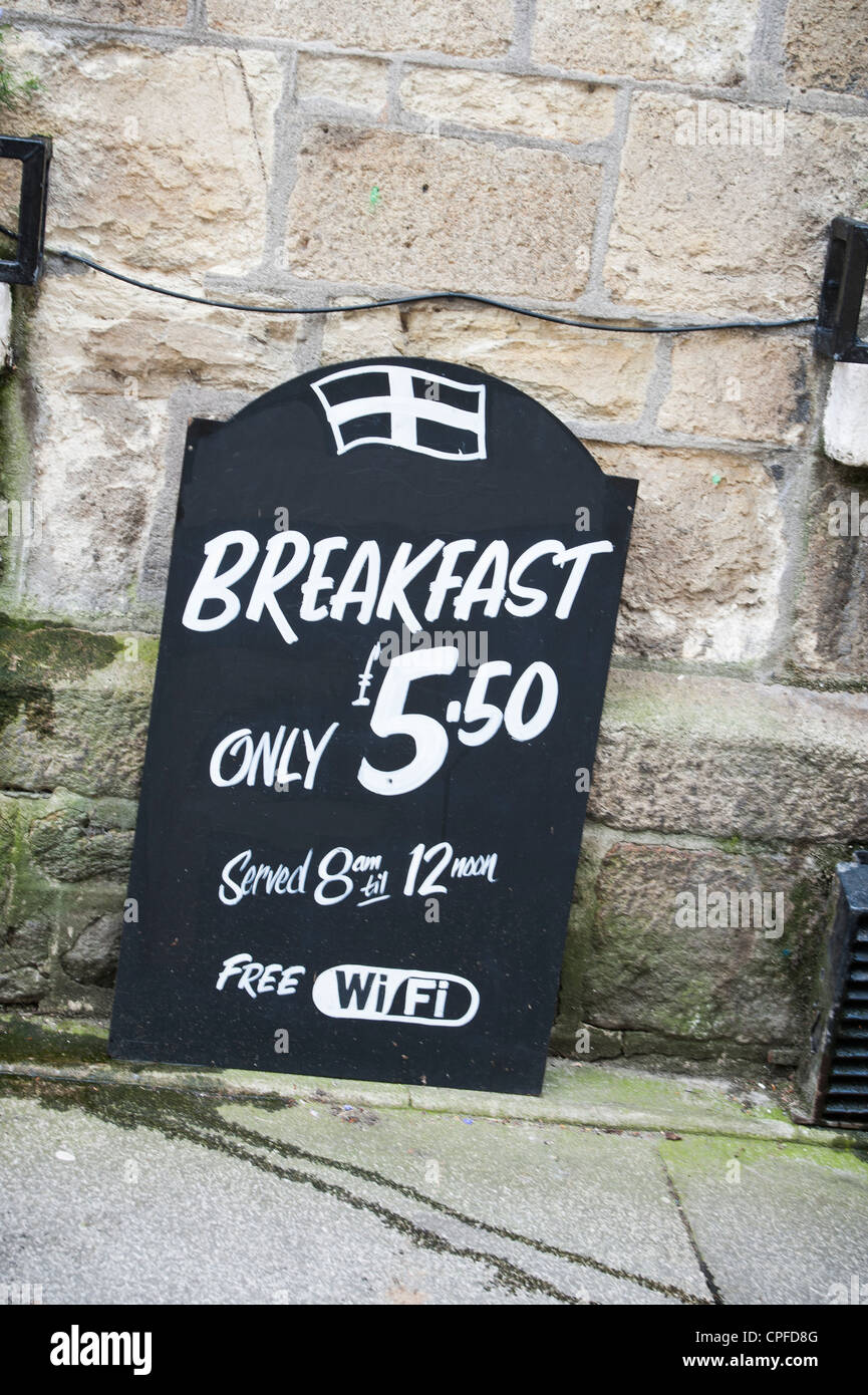 Breakfast sign outside a Cornish pub, with the Cornish flag atop offering free wifi Stock Photo