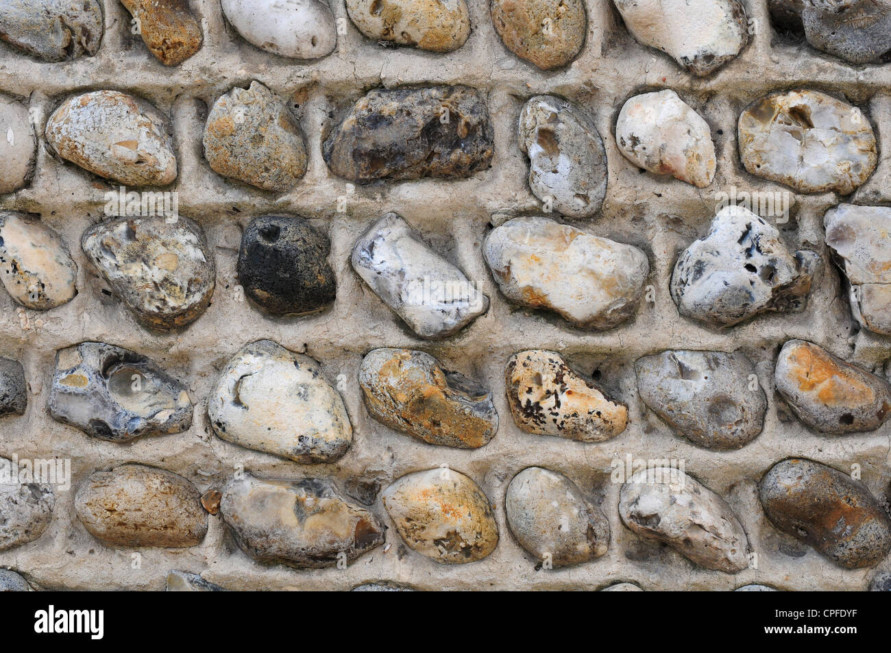 Flint cobbles used to build a wall. Stock Photo