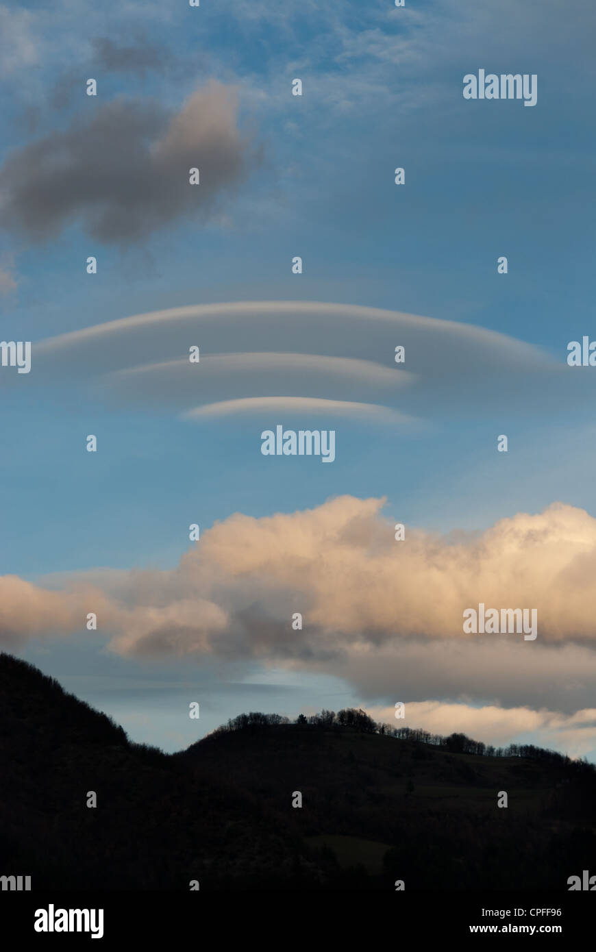 Lenticular cloud over mountains at sunset Stock Photo