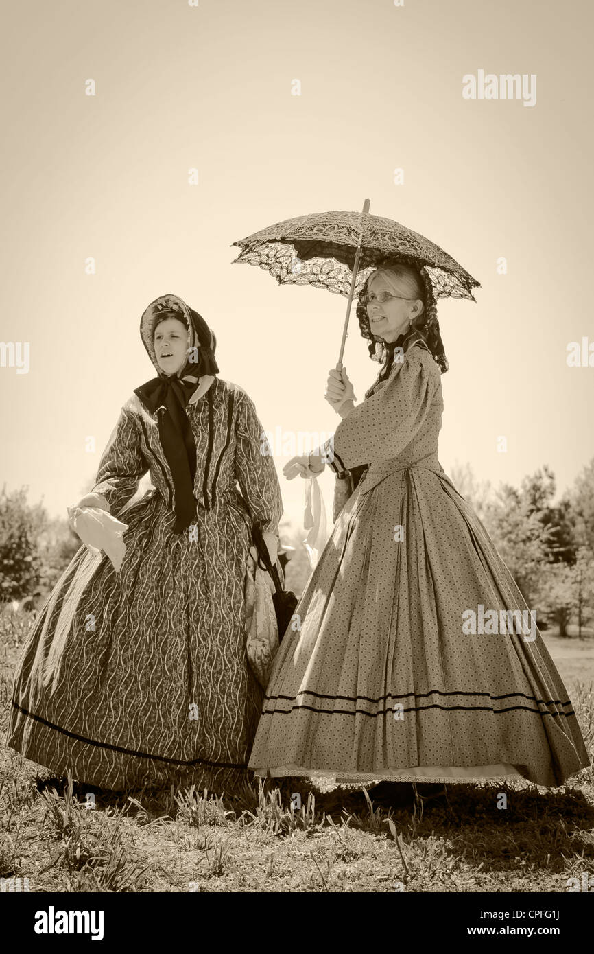 Two ladies in 19 century clothes staying under umbrella, Civil War  reenactment, Bensalem, Pennsylvania, USA Stock Photo - Alamy