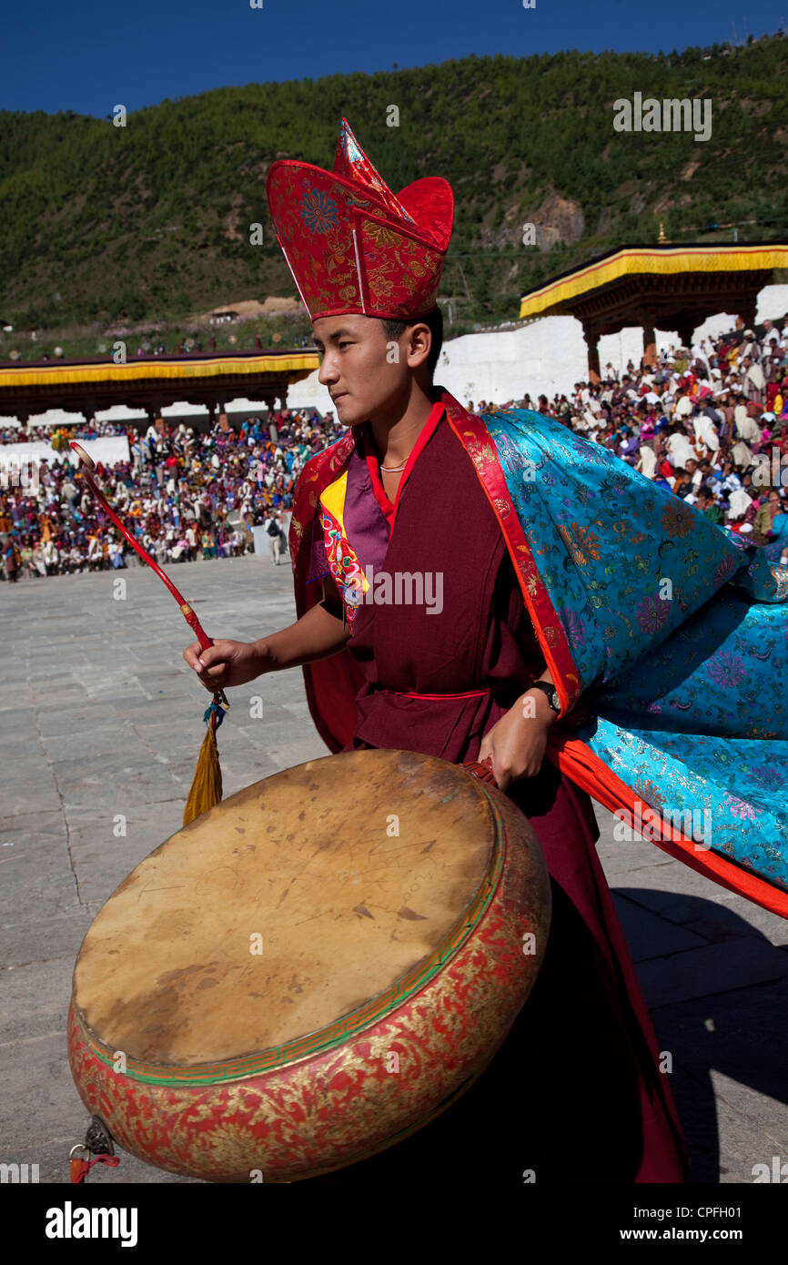 Monk beating large drum. Thimphu tsechu, Bhutan. Stock Photo