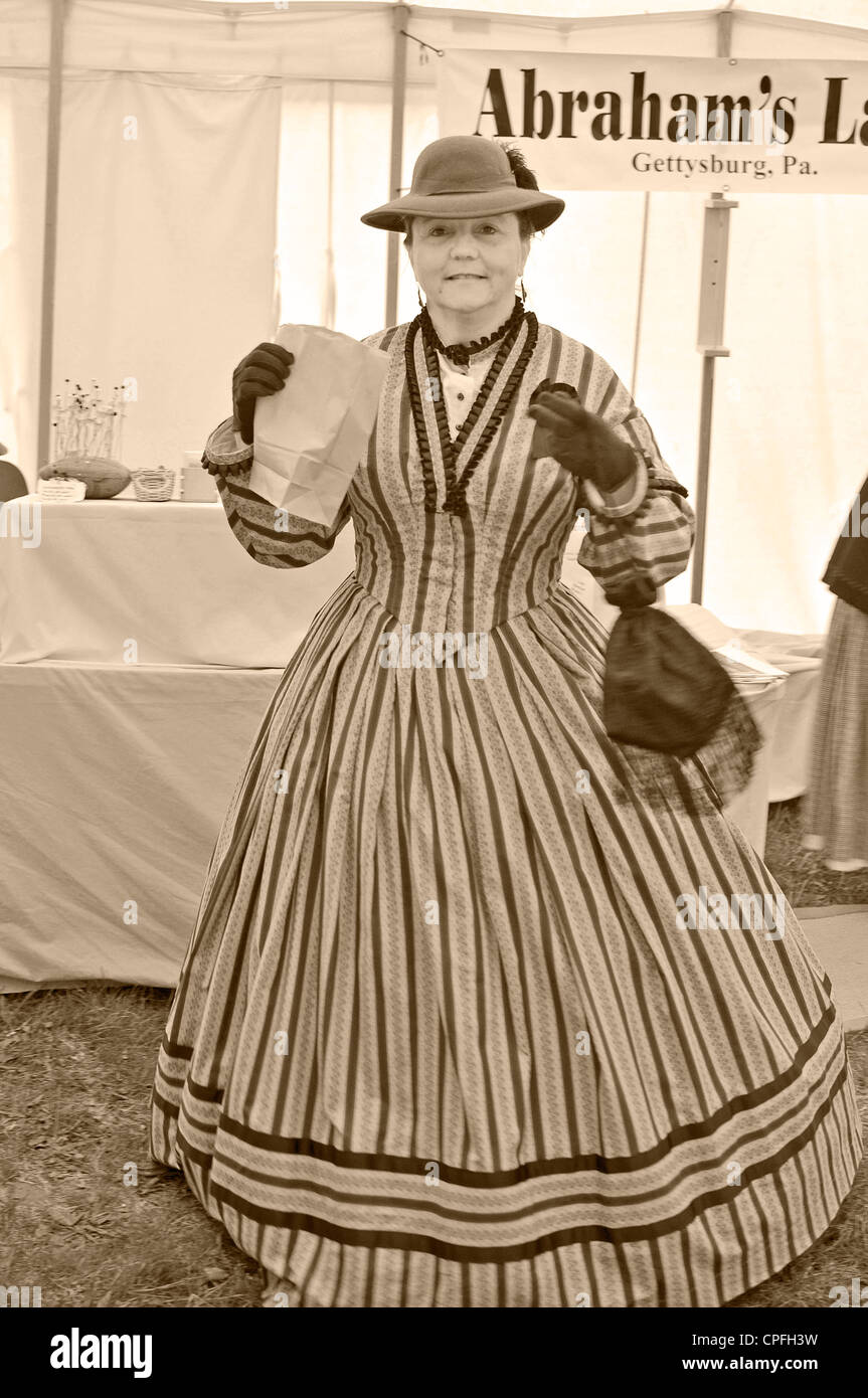 Smiling woman in 19 century clothes shopping, Civil War reenactment