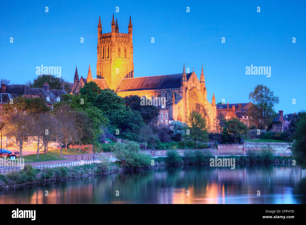 Worcester Cathedral floodlit on a spring evening and reflected in the River Severn. Stock Photo