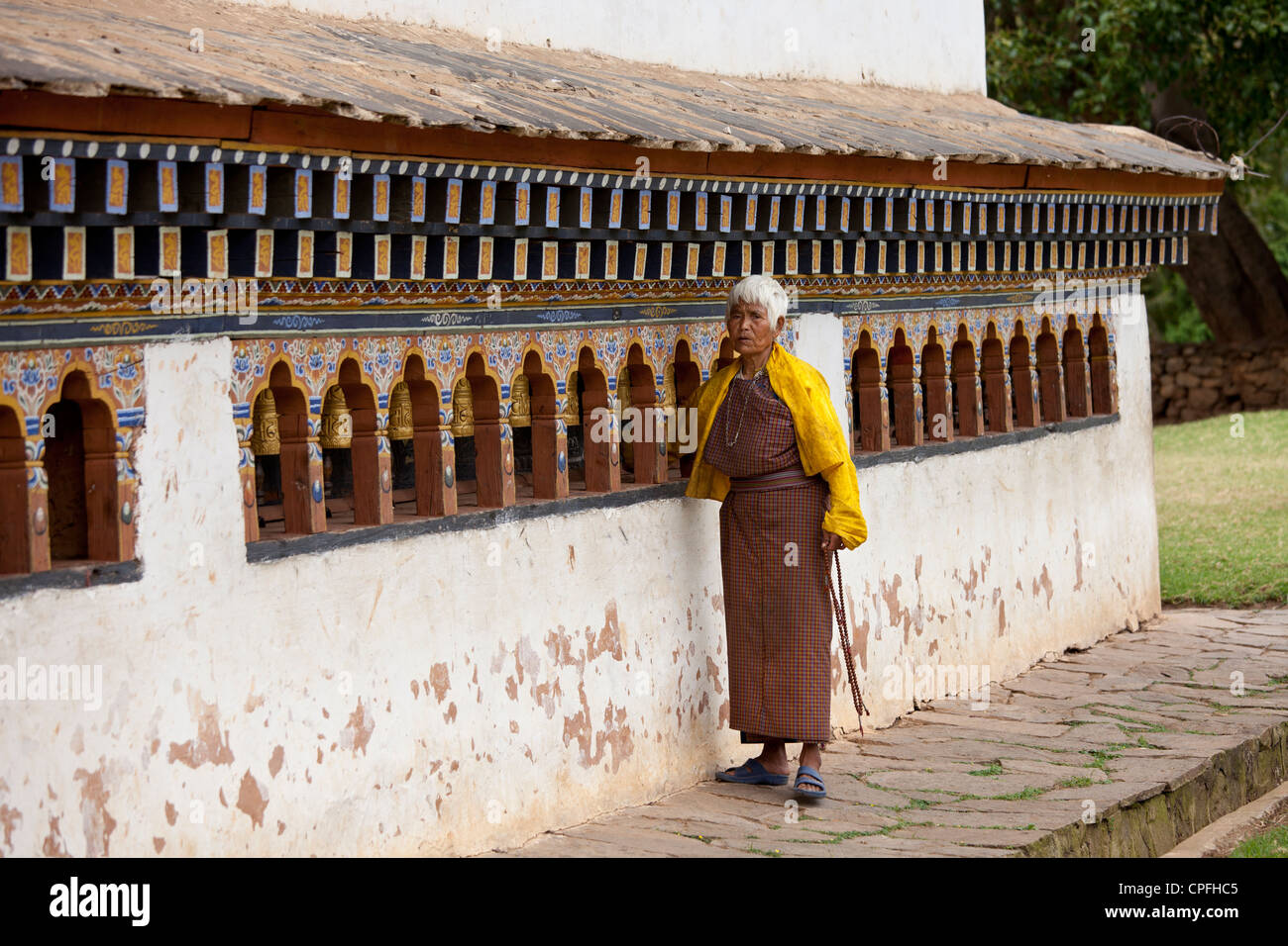 Women spinning prayer wheels at Chimi Lhakhang. Lobesa valley, Bhutan. Stock Photo
