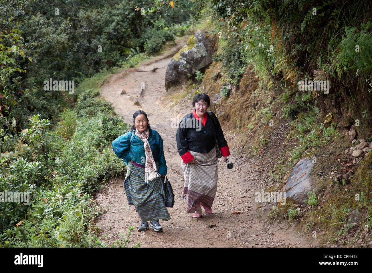 Two Bhutanese Women Hiking To Taktshang Goemba Tigers Nest Paro