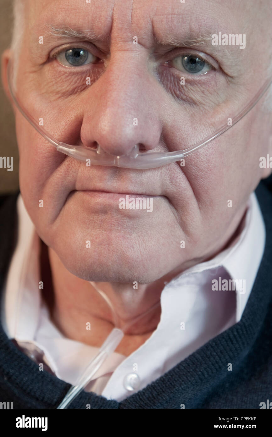 Closeup portrait of an elderly man wearing oxygen nasal tube Stock Photo