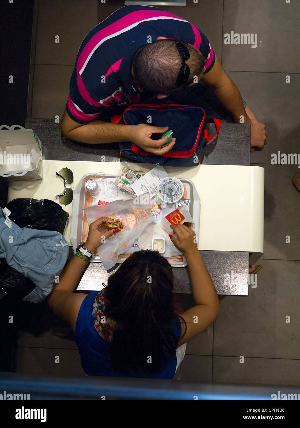 Overhead view of people eating at McDonald's Stock Photo