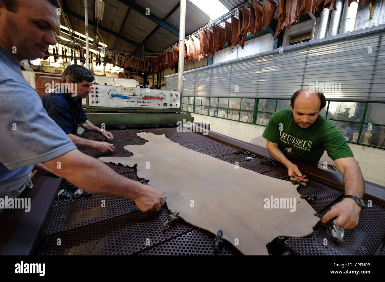 People working with leather at an industrial tannery in Portugal Stock Photo