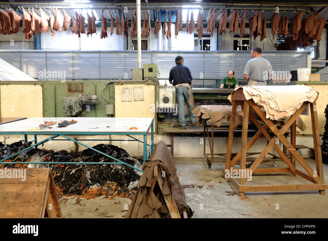 People working with leather at an industrial tannery in Portugal Stock Photo